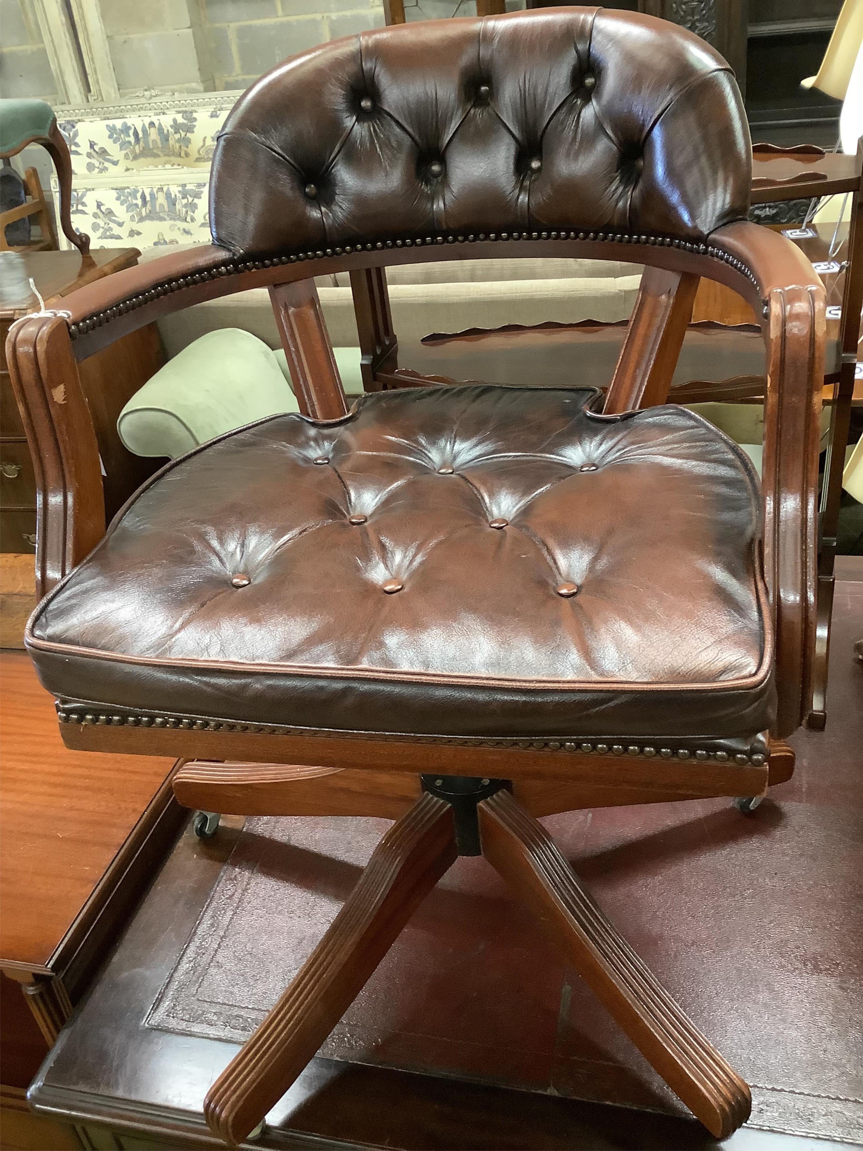 A mahogany and buttoned brown leather swivel desk armchair, width 60cm, height 84cm